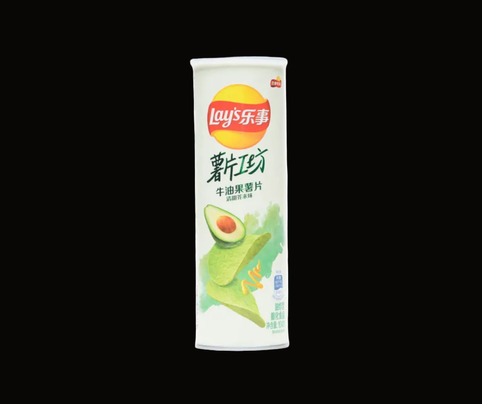 A can of Lay's Potato Chips in the Guacamole flavor, featuring a white can with green and yellow illustrations of a halved avocado and fresh potato chips, set against a solid black background.