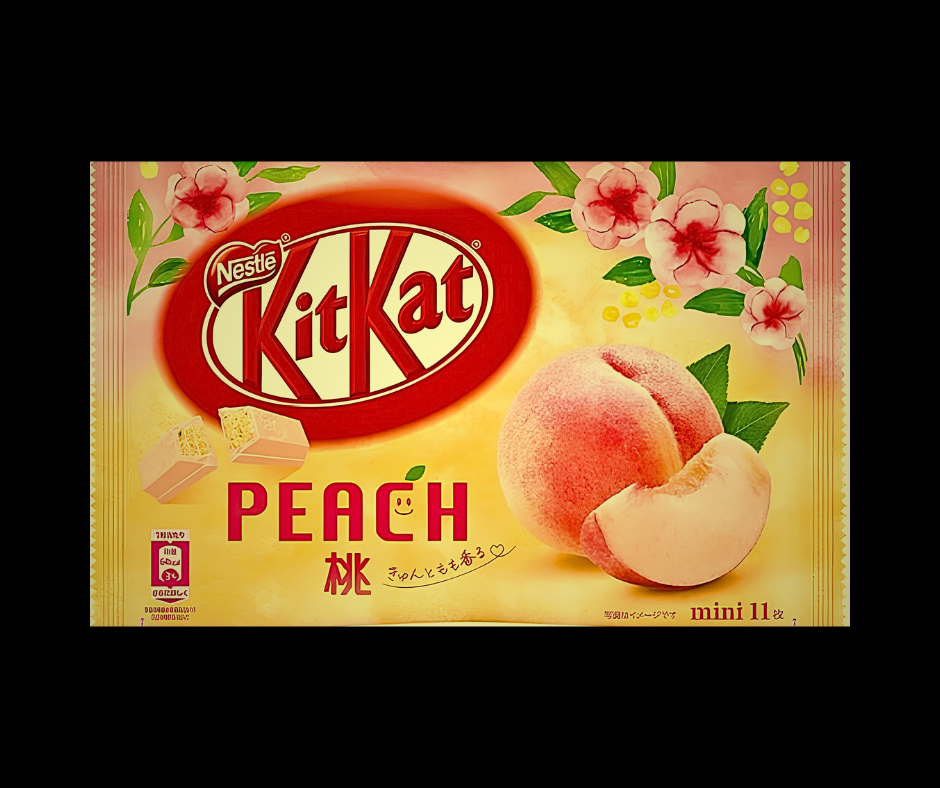 Nestle KitKat Peach chocolate bar packaging, featuring a yellow background with a large red KitKat logo, peach illustrations, and the word 'PEACH' in red text.
