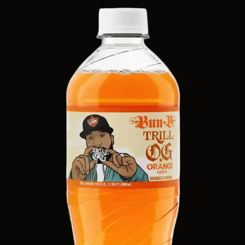 A bottle of Bun-N-Trill Orange soda on a plain white background. The clear plastic bottle is filled with bright orange liquid and has a white cap.