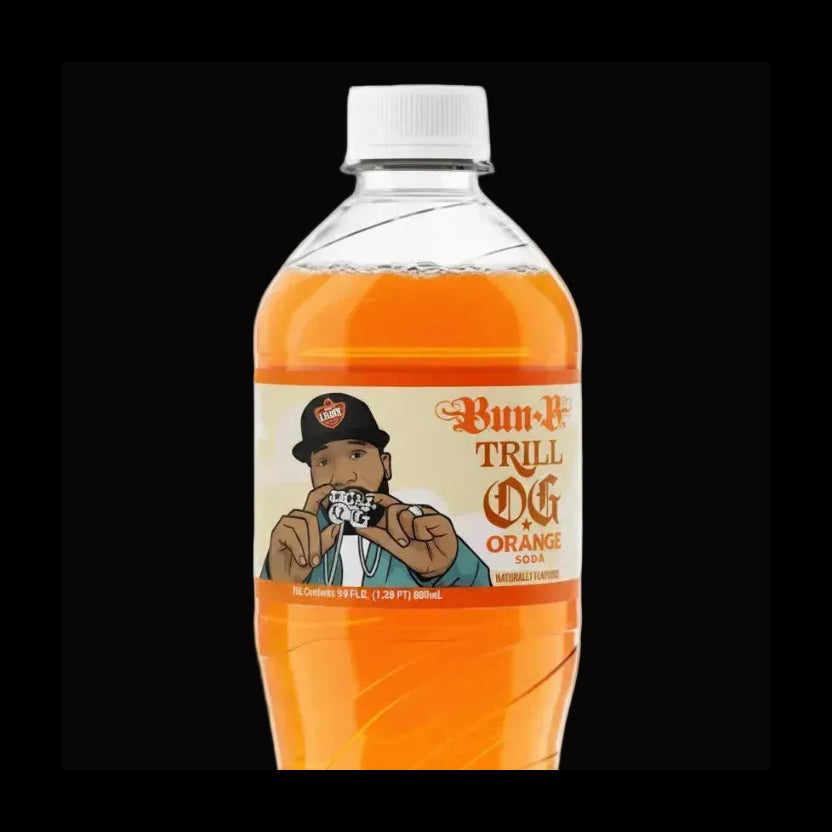 A bottle of Bun-N-Trill Orange soda on a plain white background. The clear plastic bottle is filled with bright orange liquid and has a white cap.