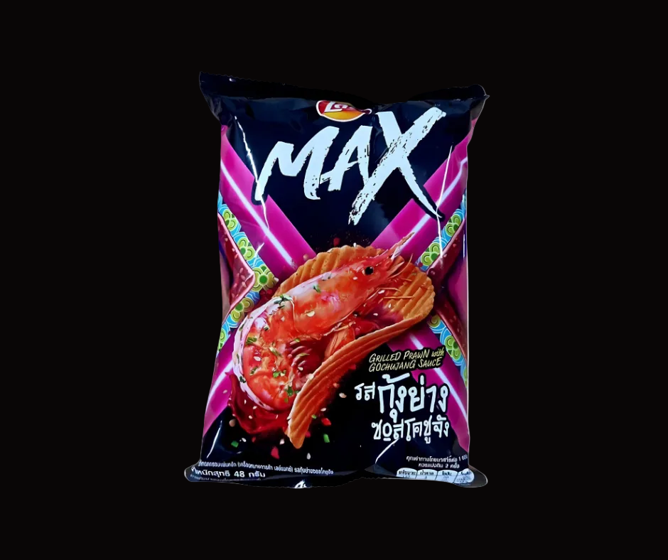 A bag of Thai snack chips branded MAX, featuring a large red prawn illustration on a black and pink package with Thai text, shown against a black background.
